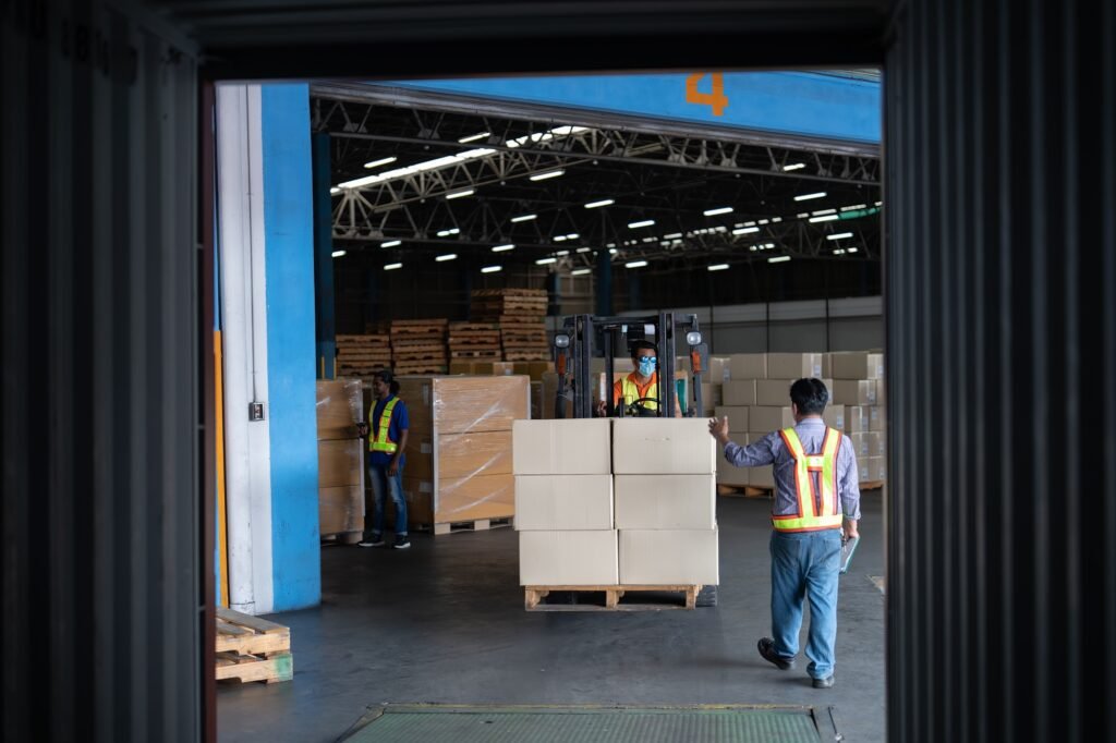 Forklift truck in warehouse drive in and out steel 40 feet steel container pick up goods boxes